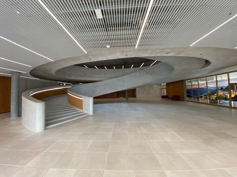 spiral staircase in a modern interior design building, tile floor, concrete ceiling