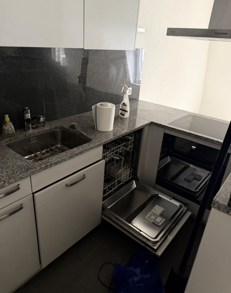 granite countertop, sink, dishwasher, stove, kitchen cabinet, countertop storage box, plastic bag on the floor