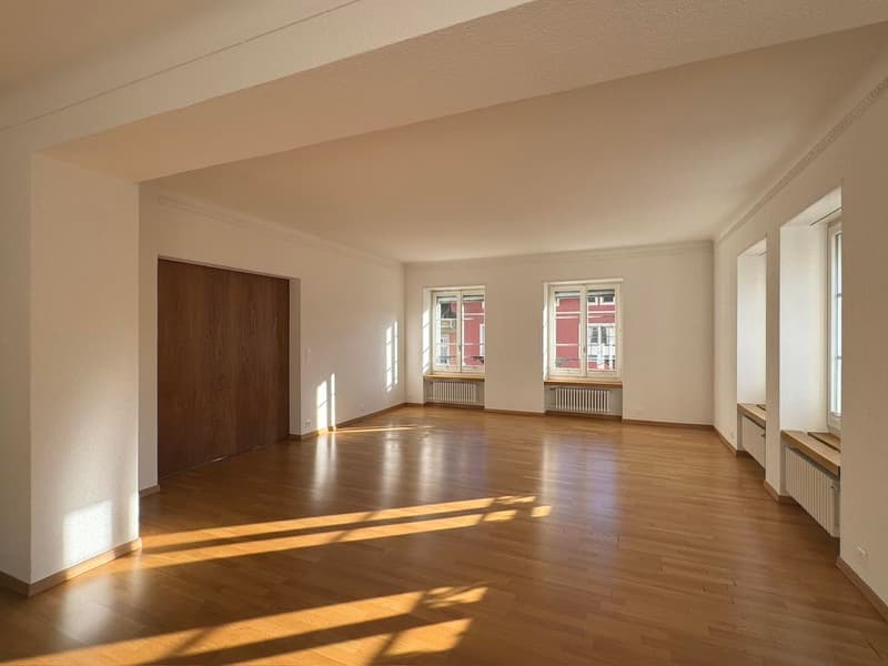 empty room, wooden floors, large windows, heating, arched doors