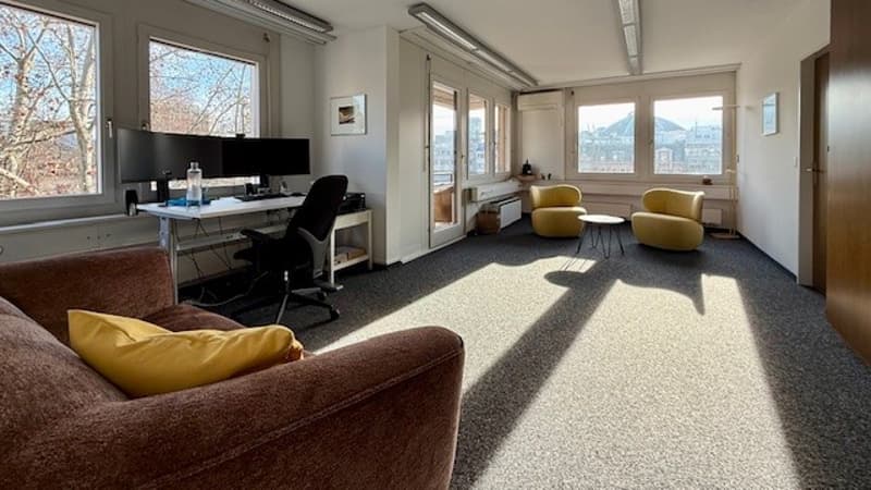 desk, monitors, computer chair, two chairs, table, couch, picture frame, radiator