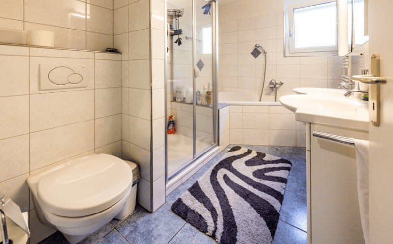 modern bathroom with walk-in shower, bathtub, sink, and toilet