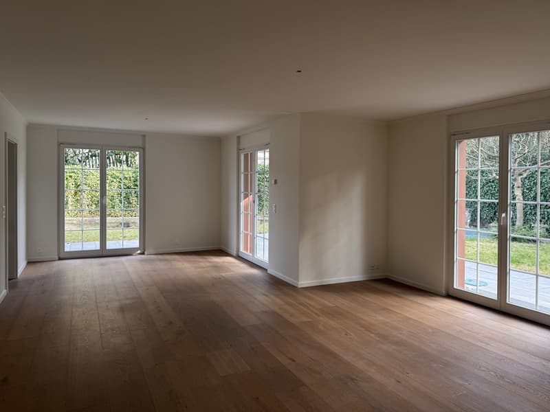 empty room, wooden floors, large glass doors, white walls, balcony