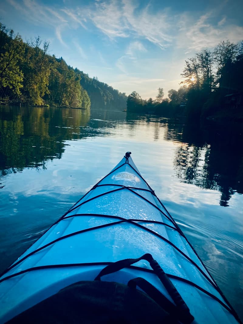 View of the river with mountains and forest around, kayak in the front