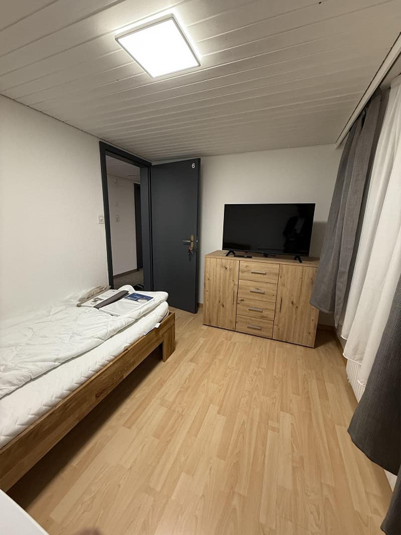 wooden floor, bed, tv, wooden cabinet, curtains