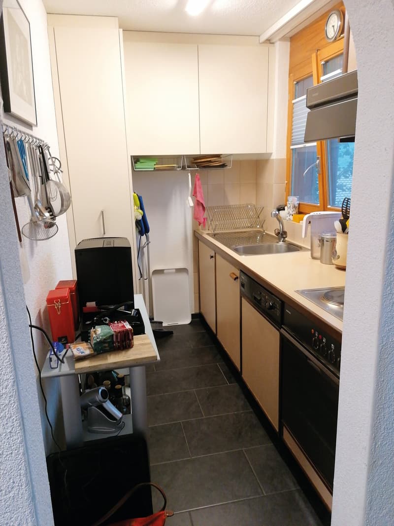 kitchen with sink, stove, dishwasher, cabinets, and a window