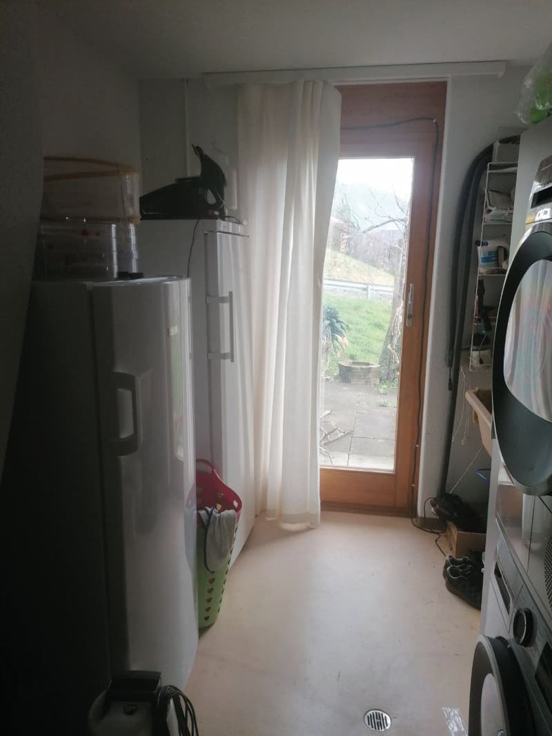 A small room with a refrigerator, washing machine, and dishwasher.