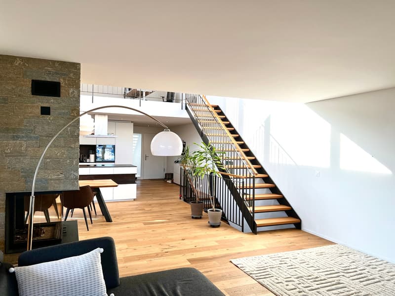 wooden floor, fireplace, staircase, modern design, large windows, open kitchen, dining table, couch, lamp, rug
