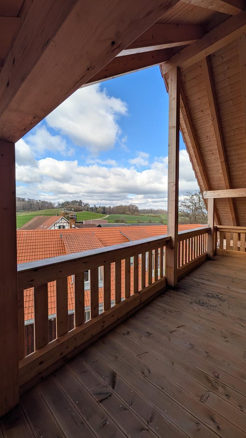 wooden floor, wooden beams, wooden railing, view of the landscape