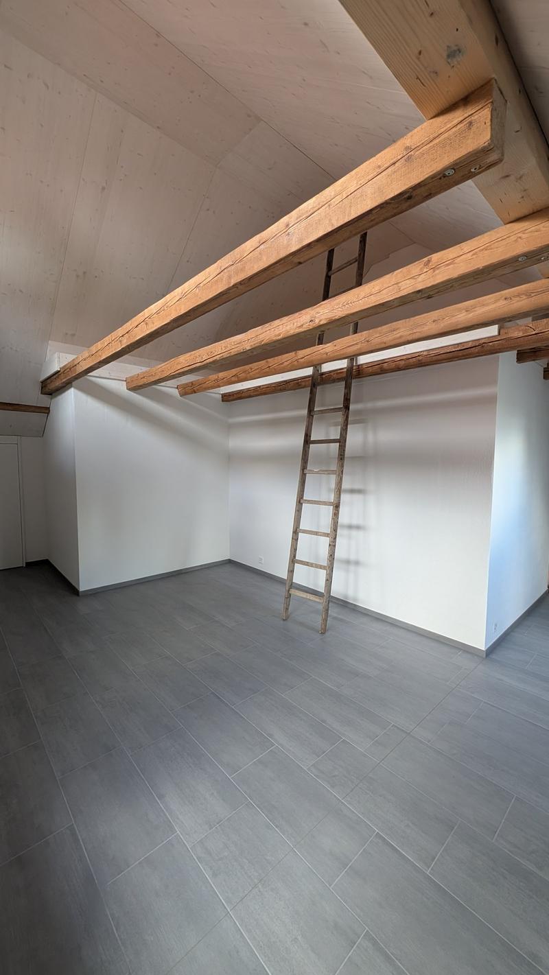 empty room, wooden beams, wooden ladder, gray tiles