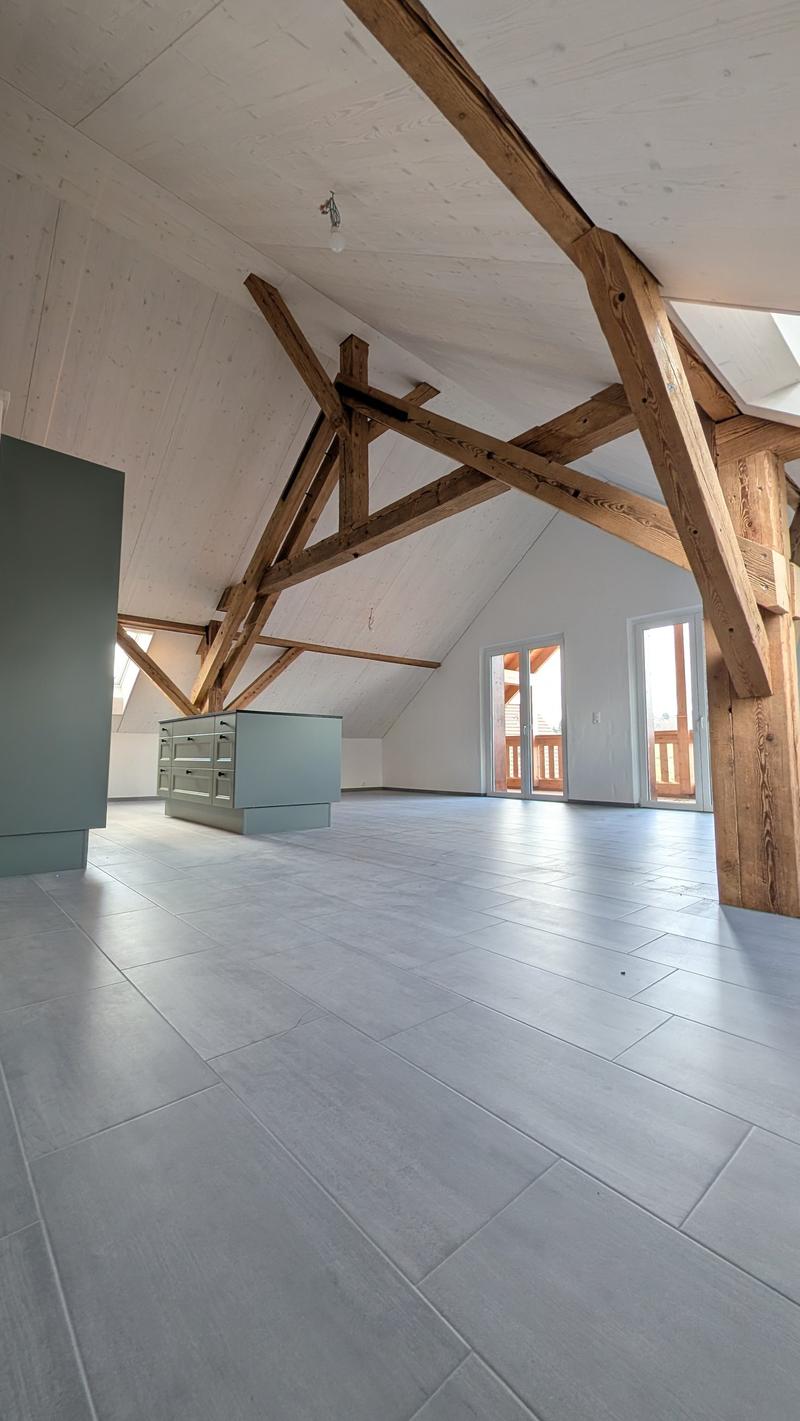 empty room, wooden beams, gray tiles, kitchen island, windows
