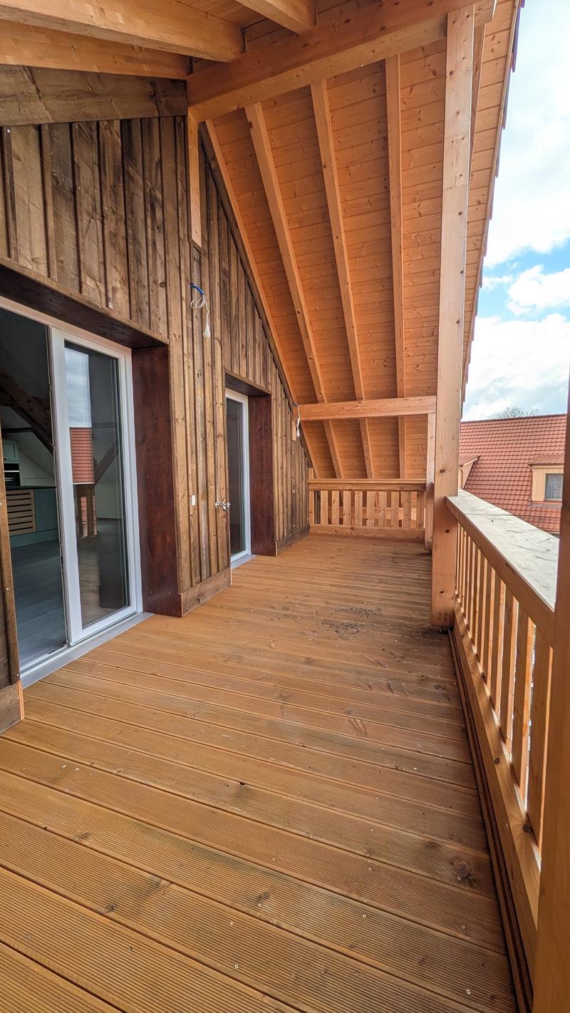 wooden floor, wooden walls, glass doors, wooden railings, balcony