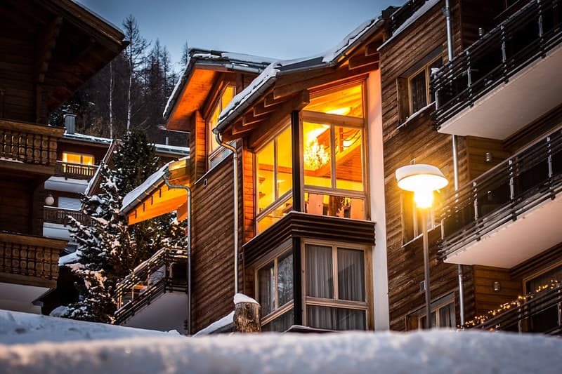Wooden chalet style, multi-storey, balconies, illuminated windows, street lighting