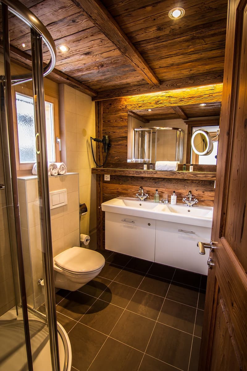 Walk-in shower, double sink, modern wooden design, wooden beams, window