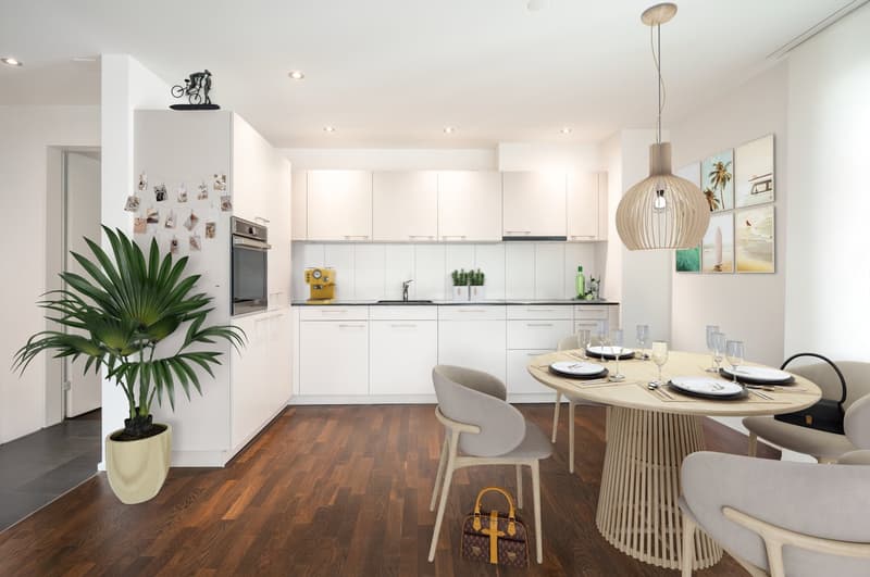 modern kitchen with white cabinets, wooden floor, dining table with chairs, potted plant, modern pendant light, wall art