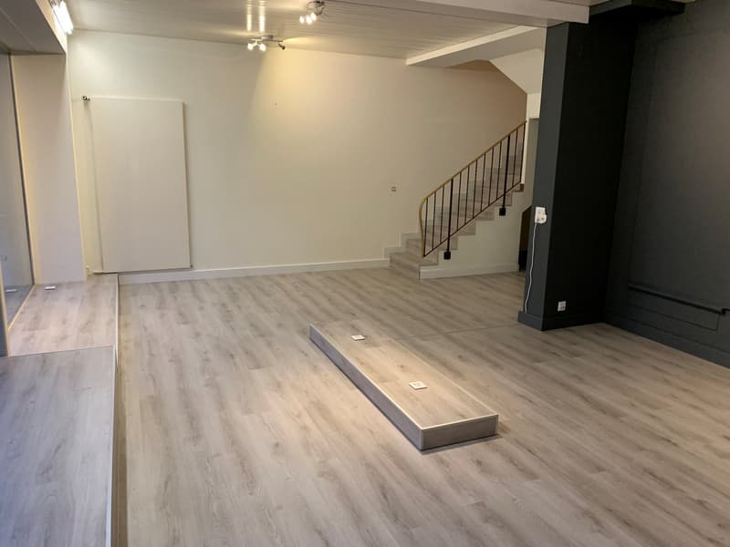 empty room, wooden floor, white walls, staircase, power outlets
