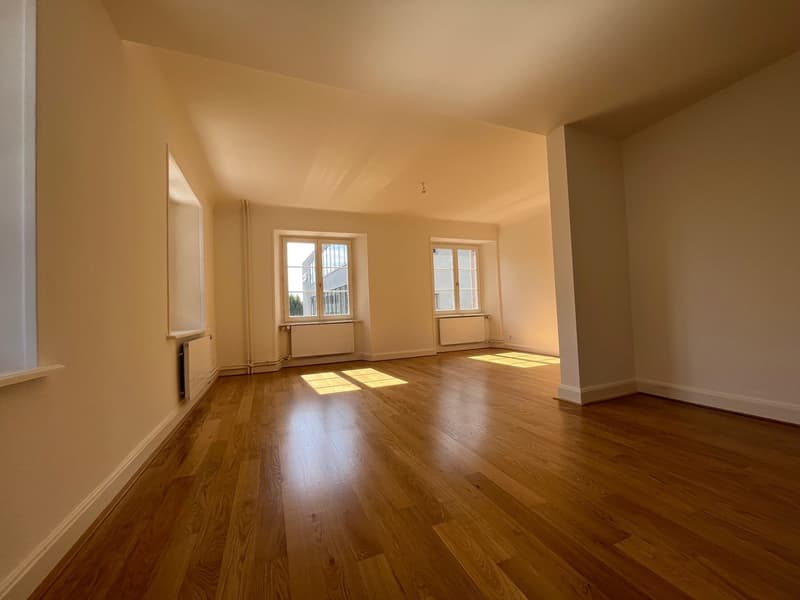 empty room with hardwood floors, windows, and radiators
