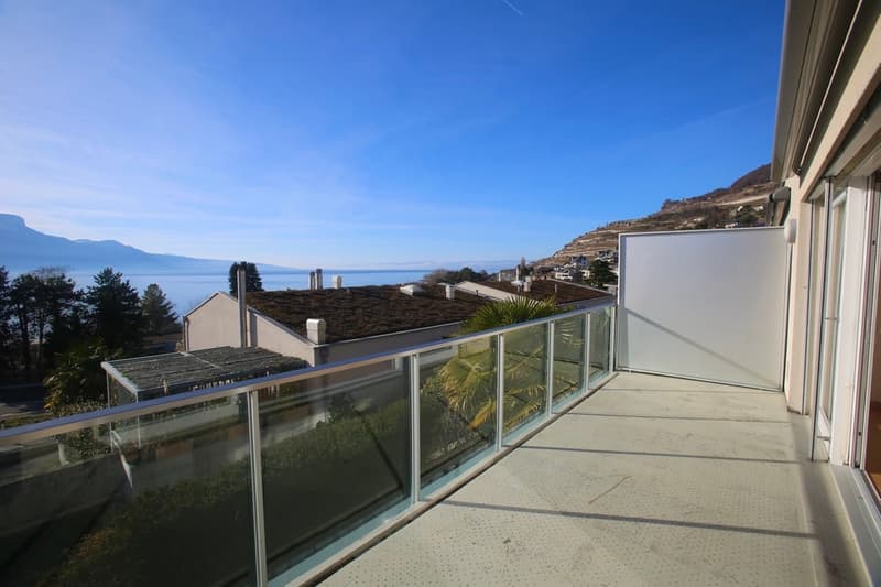 Glass railing, floor tiles, unobstructed view of the lake