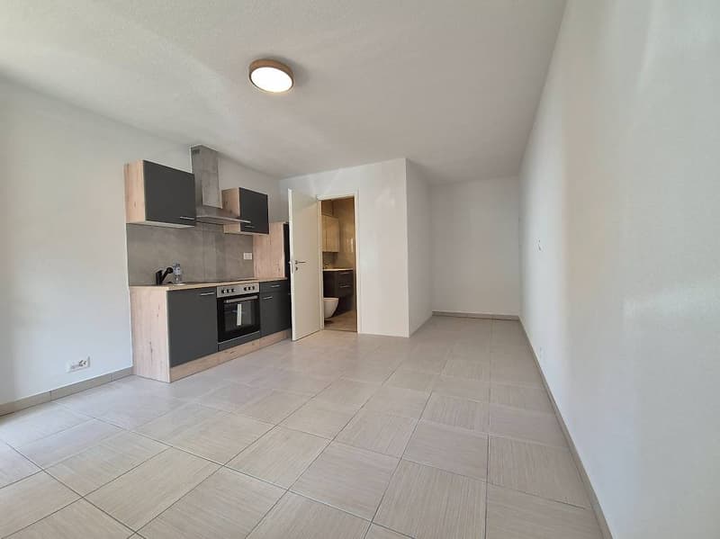 Empty kitchen, white tiles, wooden cabinets, built-in oven, countertop, sink, white walls