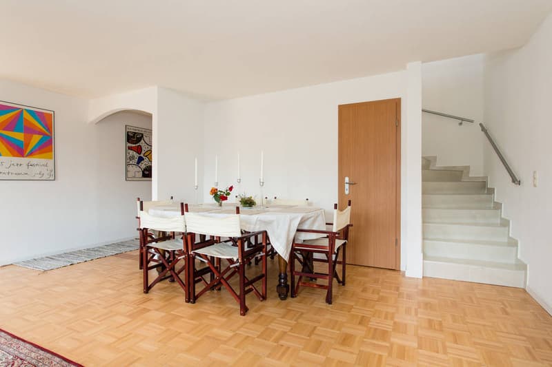 white walls, wooden floor, dining table, chairs, painting, staircases