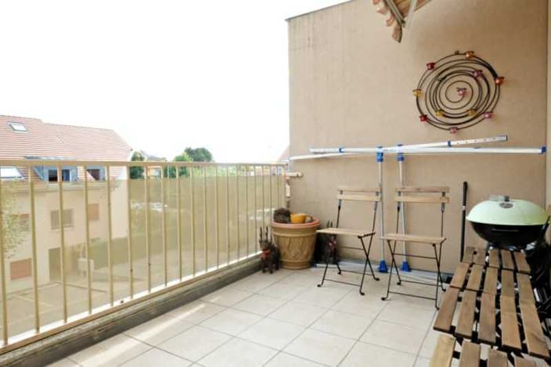 Metal railing, tile floor, seating area, BBQ, plants, wall art, metal poles