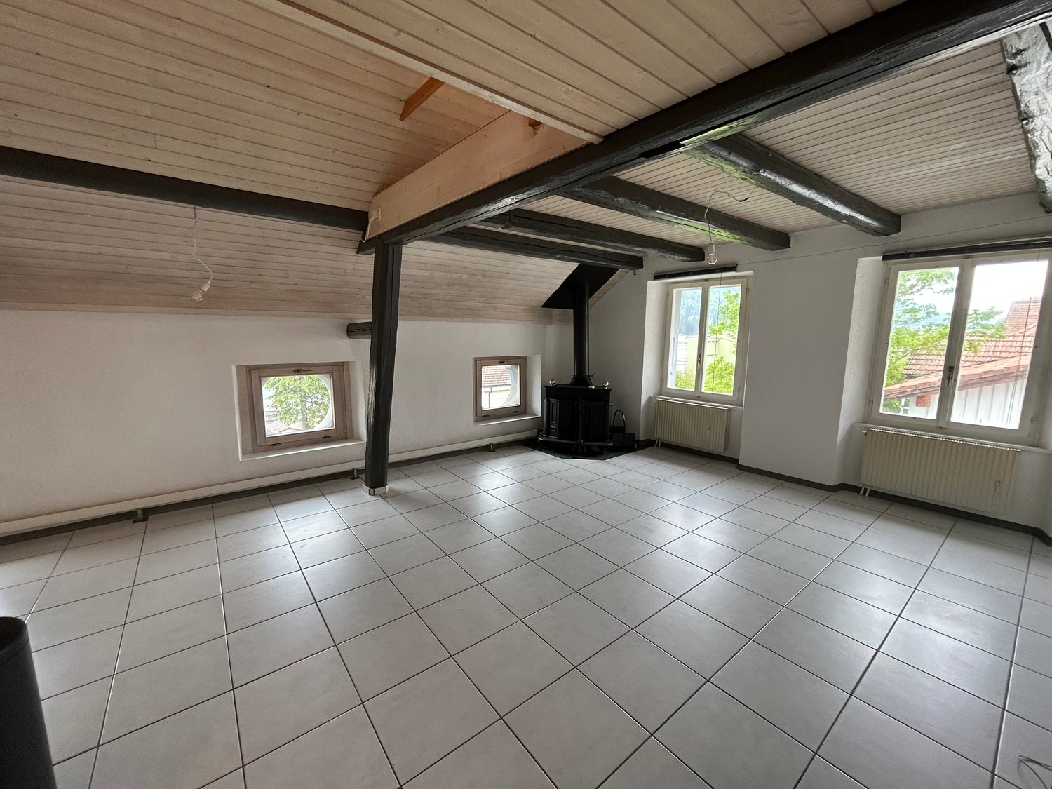 empty room, white tiles, wooden beams, fireplace, windows