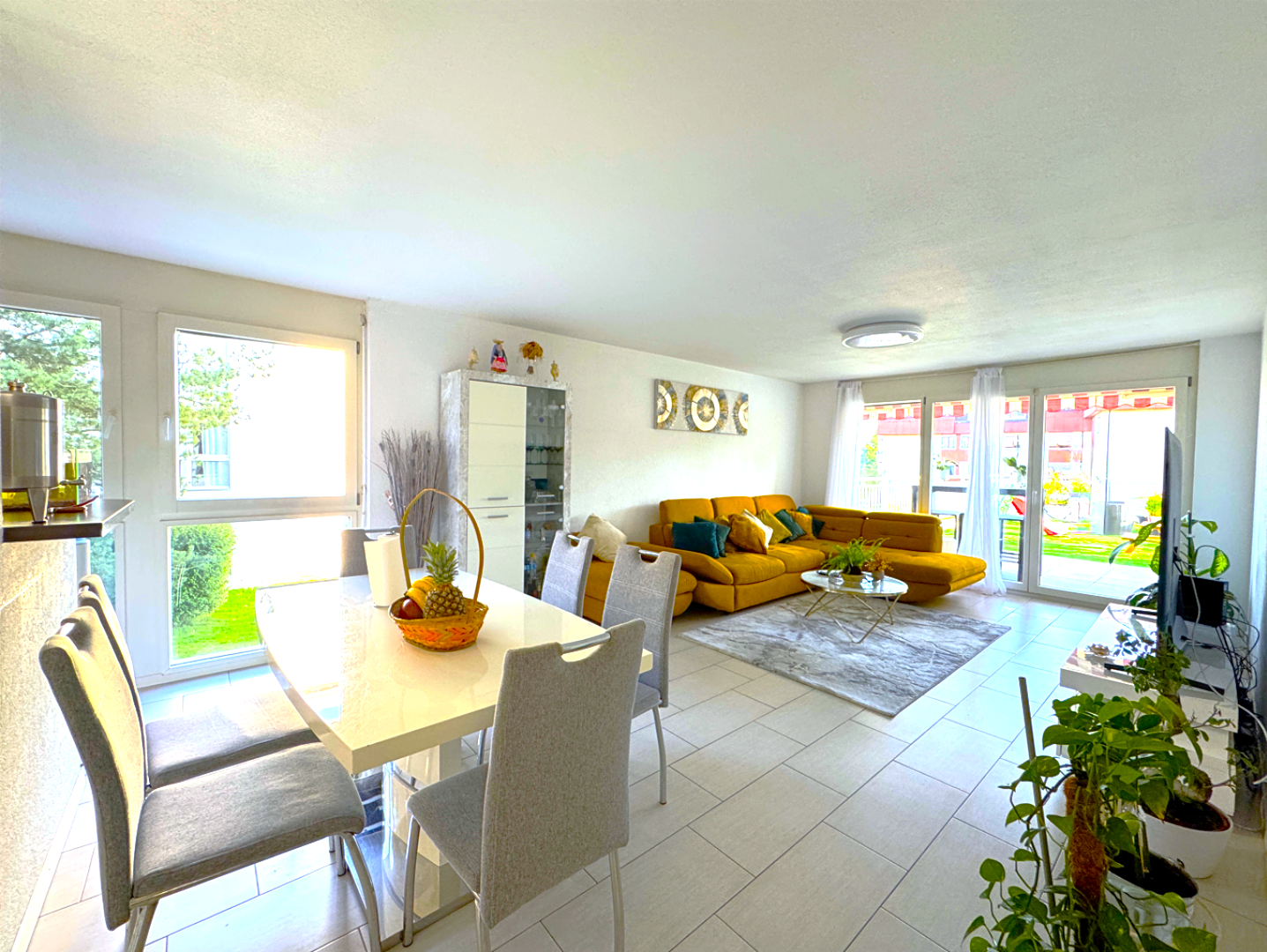 modern design, beige sofas, yellow walls, white dining table, large windows, balcony
