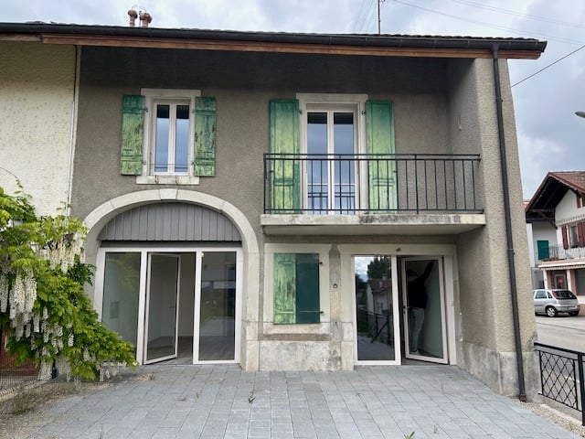 2-story house, green shutters, arched entrance, balcony, brick exterior, tile floor