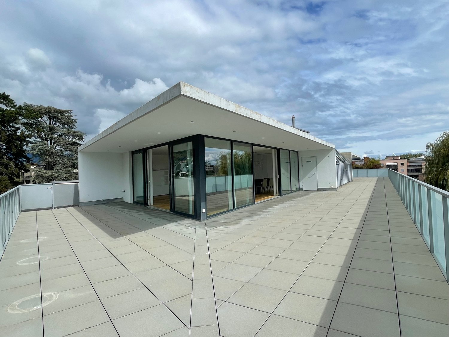 modern design, rooftop terrace, raised ground floor, sliding glass doors, city view