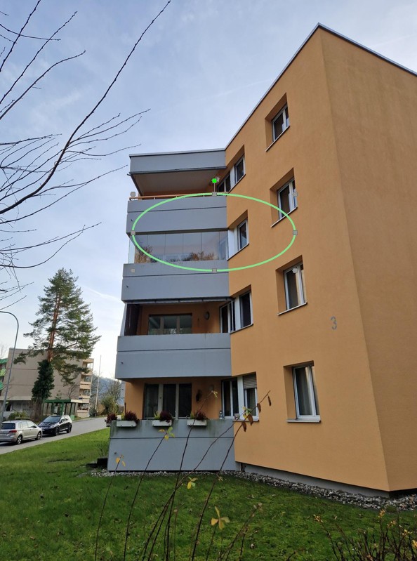 3-story apartment building with beige paint, balcony, glass windows, outdoor plant boxes