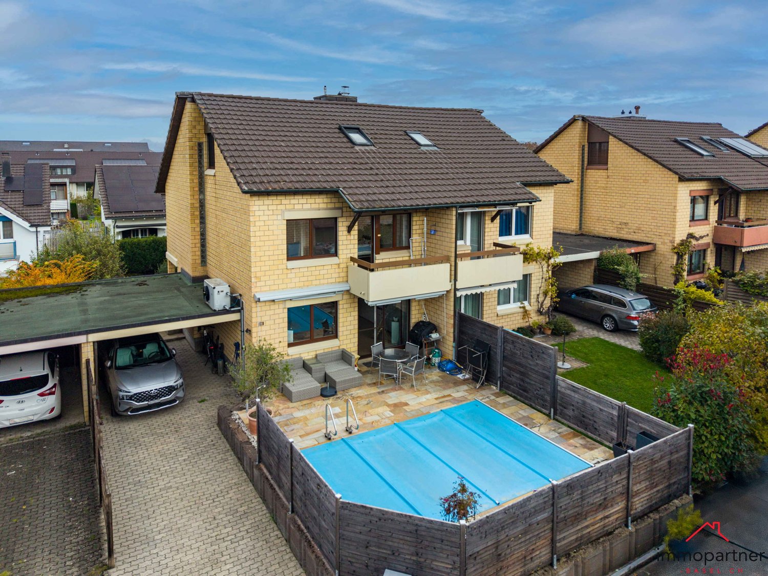 Three story townhouse, covered parking, backyard with swimming pool and covered terrace, brick walls