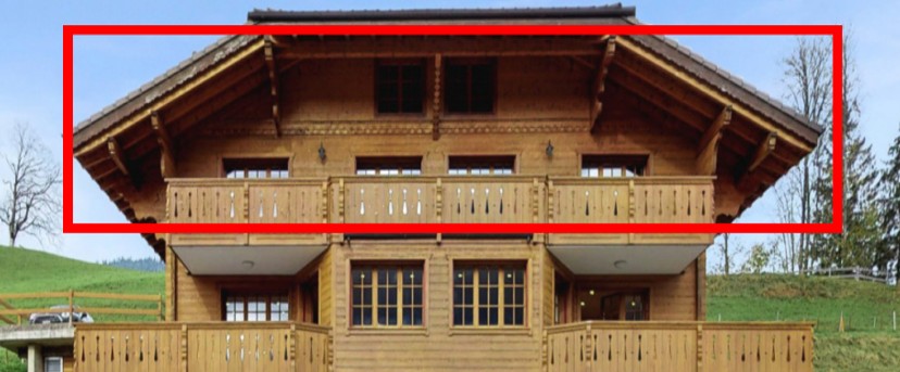 Wooden chalet with multiple balconies, sloped roof, garden