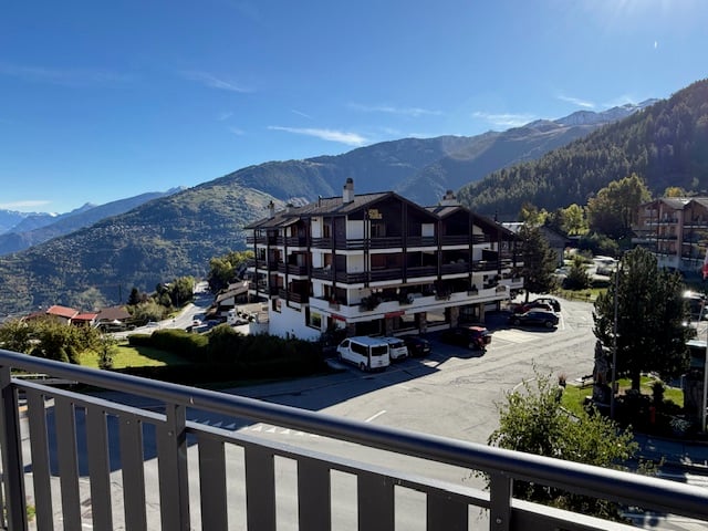 large chalet style building with mountains in the background
