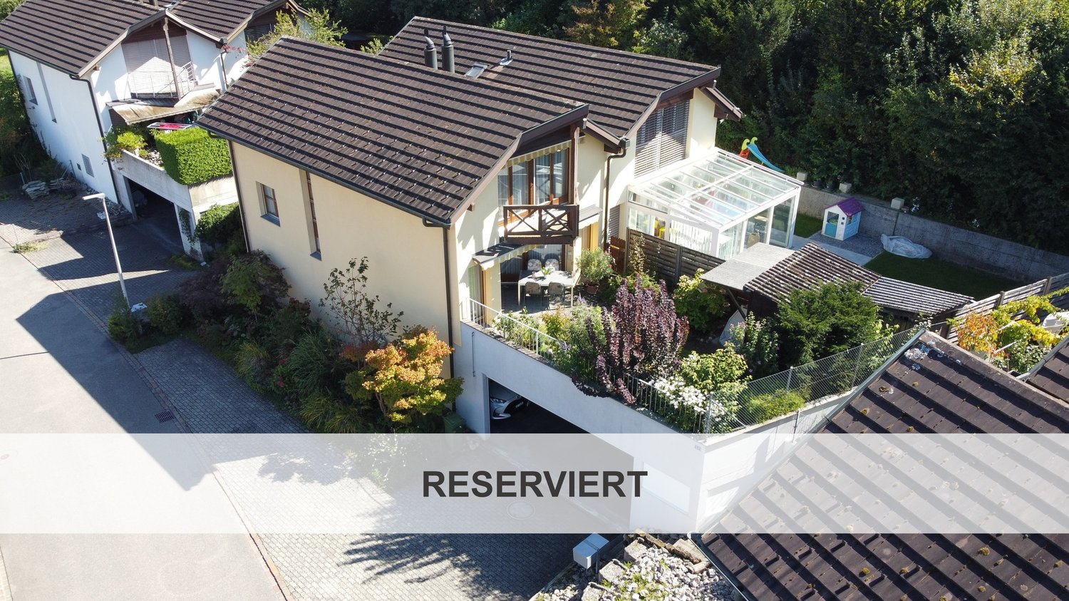 2 story house, brown roof, white walls, balcony, terrace, garage, raised ground floor