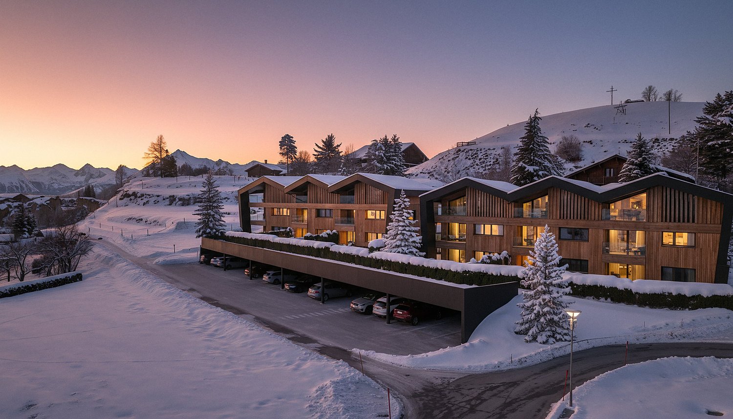 Modern building with wooden facade, large windows, covered parking, snow covered landscape