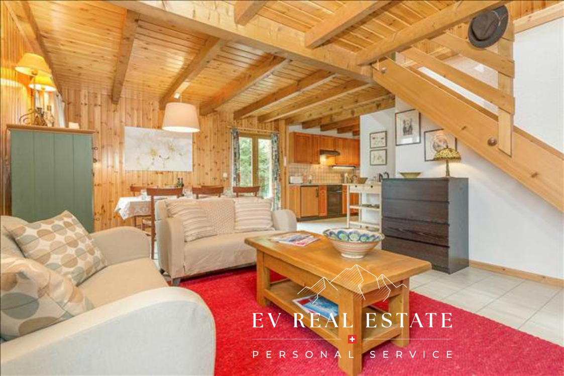 Wooden ceiling, two sofas, coffee table, dining table with chairs, wooden cabinets, pictures on the wall