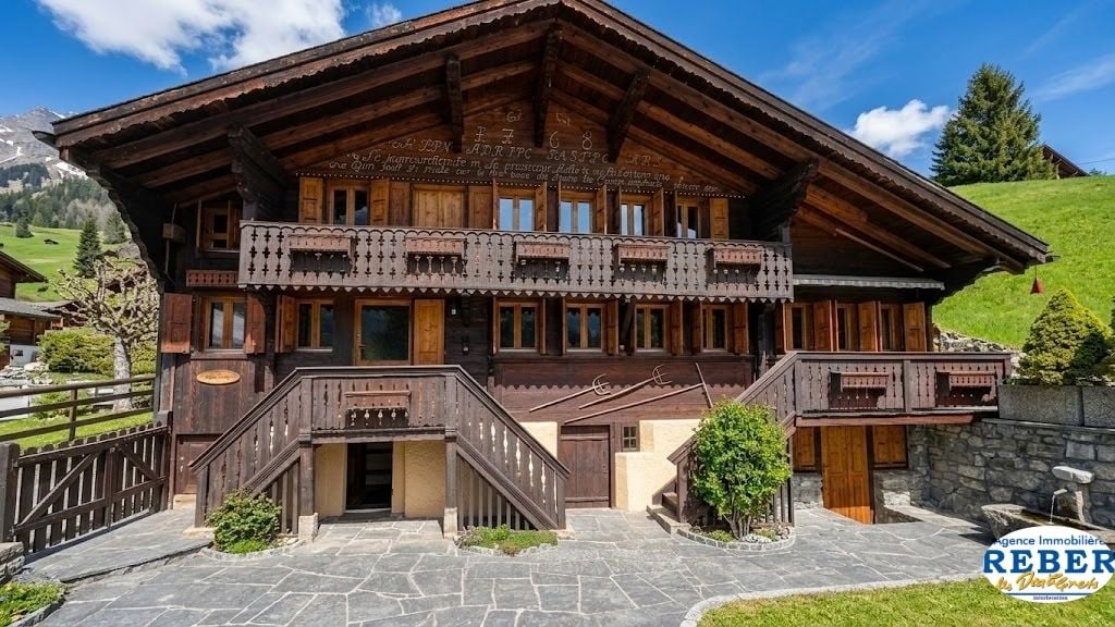 wooden chalet, 3 stories, wooden balcony, stone wall, wooden fence, garden
