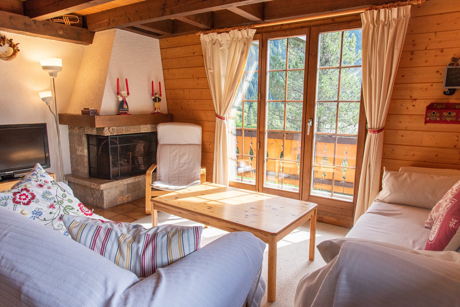 living room, fireplace, glass doors, couch, table, lamp, TV