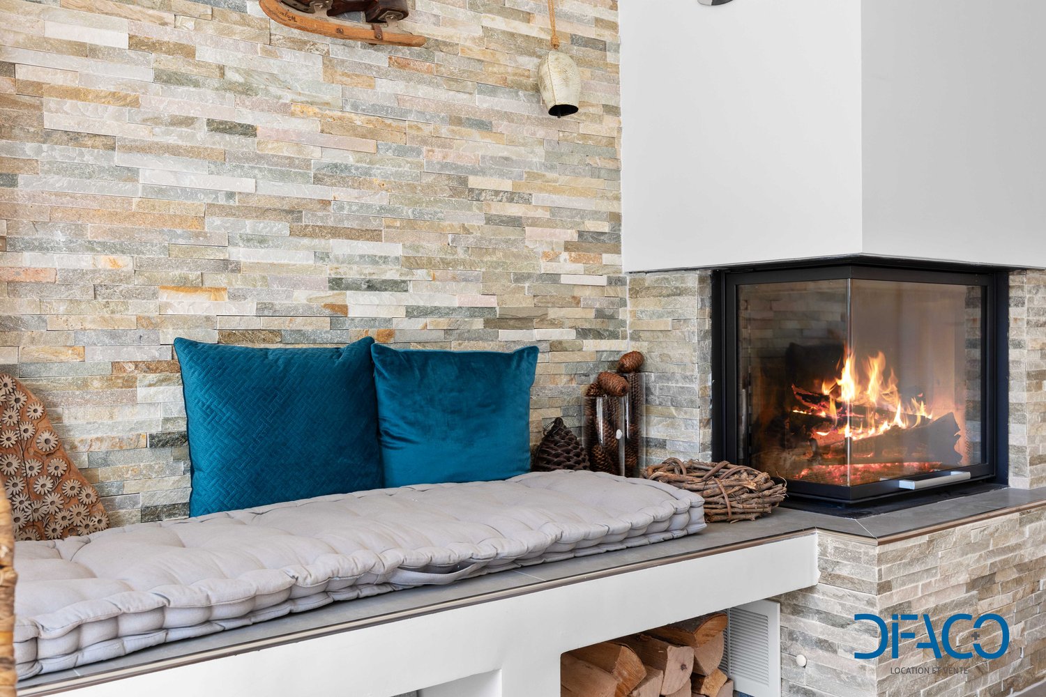 stone wall, fireplace, cushions, decorative elements