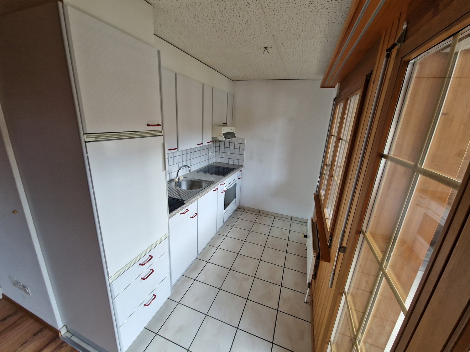 modern kitchen, white cabinets, stainless steel appliances, tiled floor, power outlet