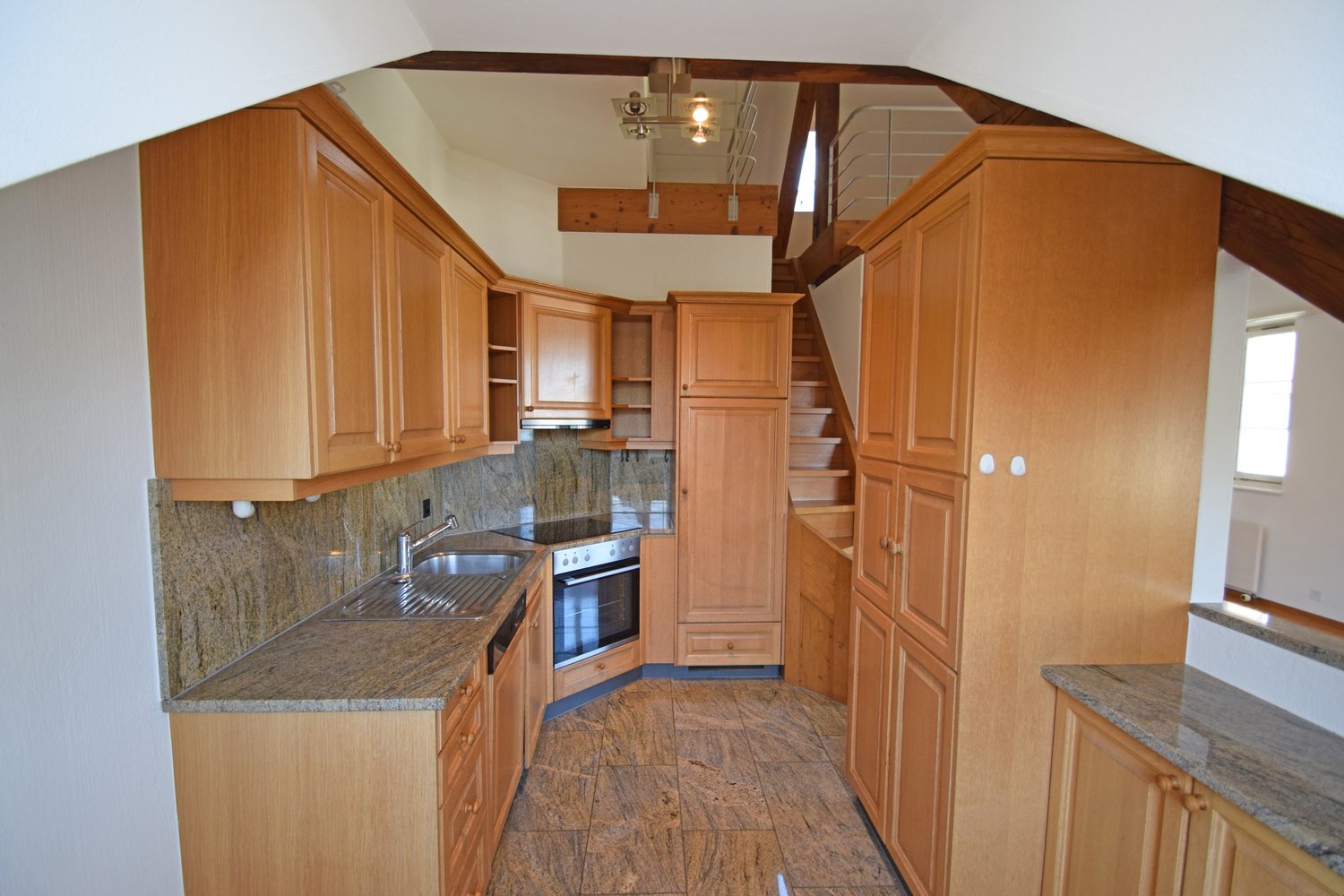 open kitchen, wooden cabinets, granite countertops, electric oven, stainless steel sink, faucet
