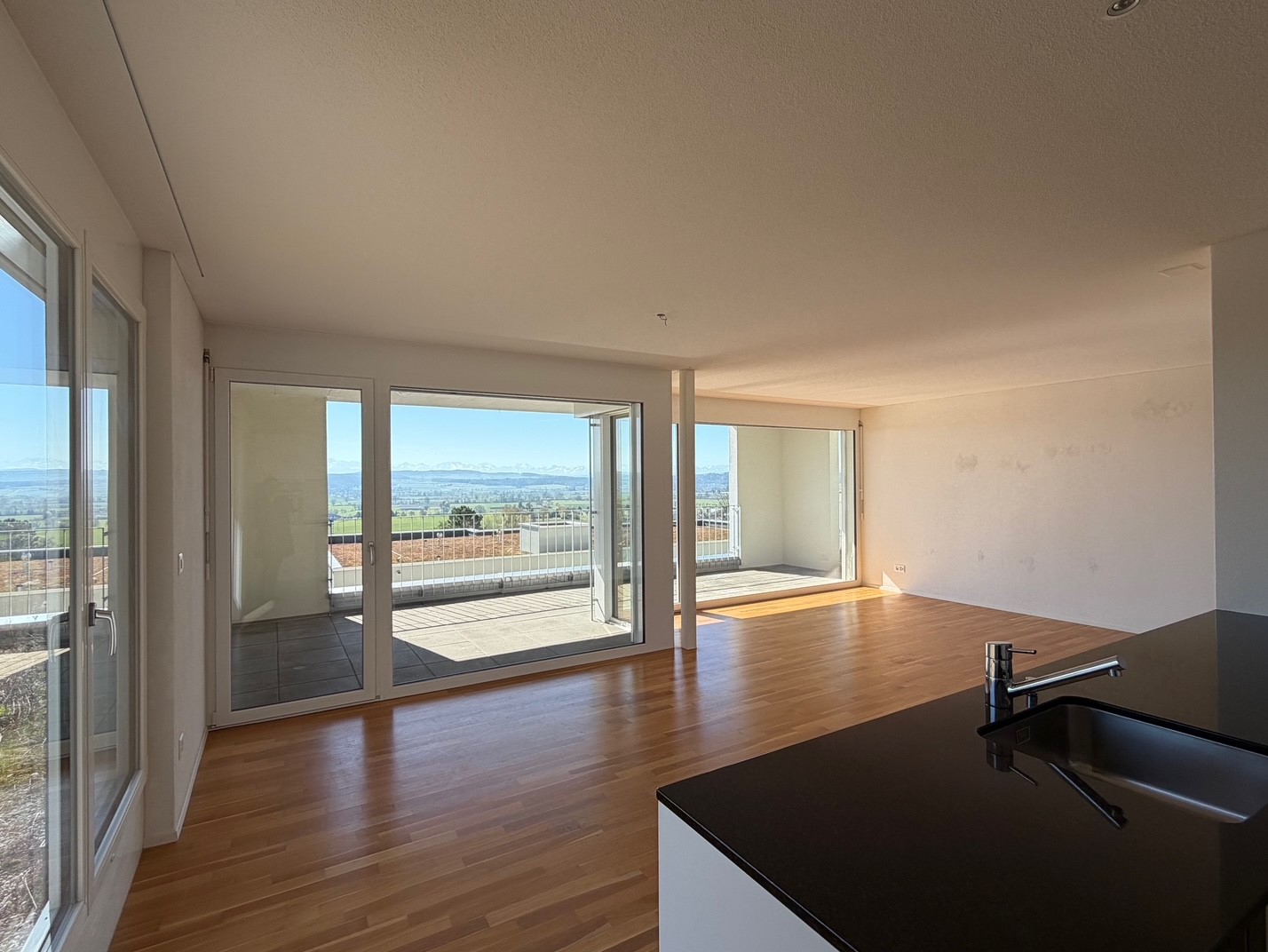 Open kitchen, large windows, balcony, wooden floor, modern design, sink, faucet