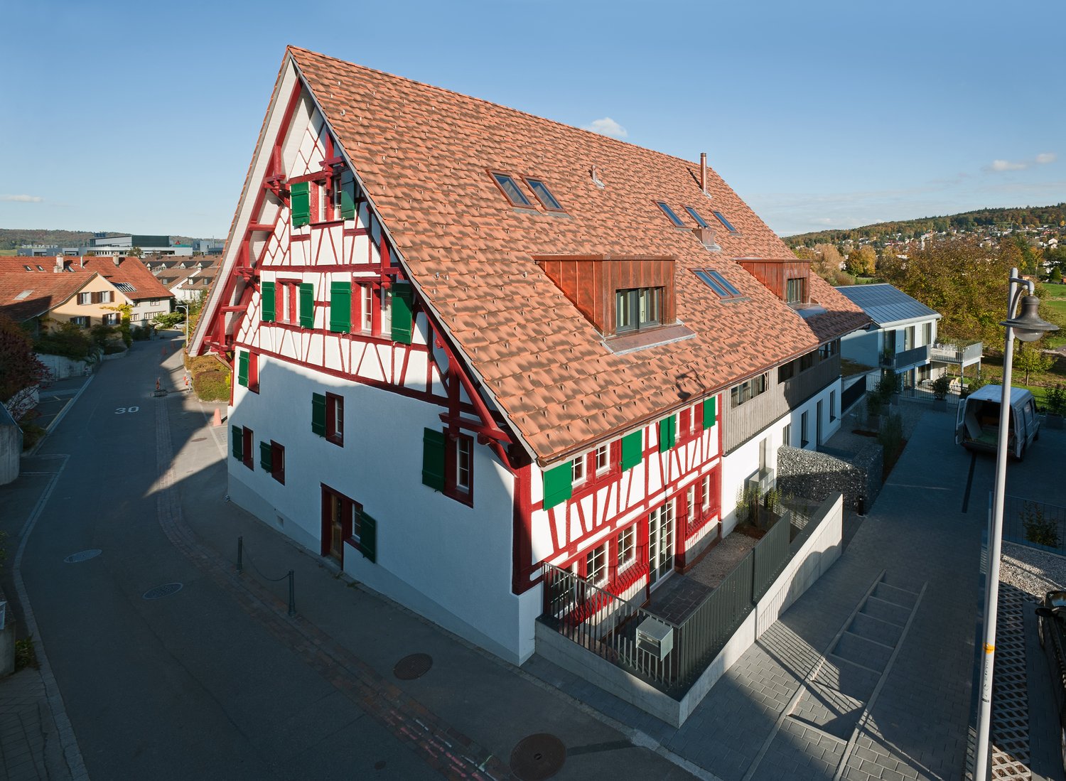 two story house, red roof, red and white accents, red chimney, green shutters