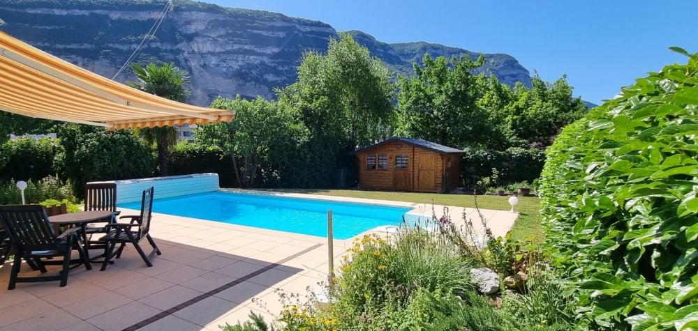 Swimming pool, outdoor table and chairs, wooden house, terrace, plants and trees