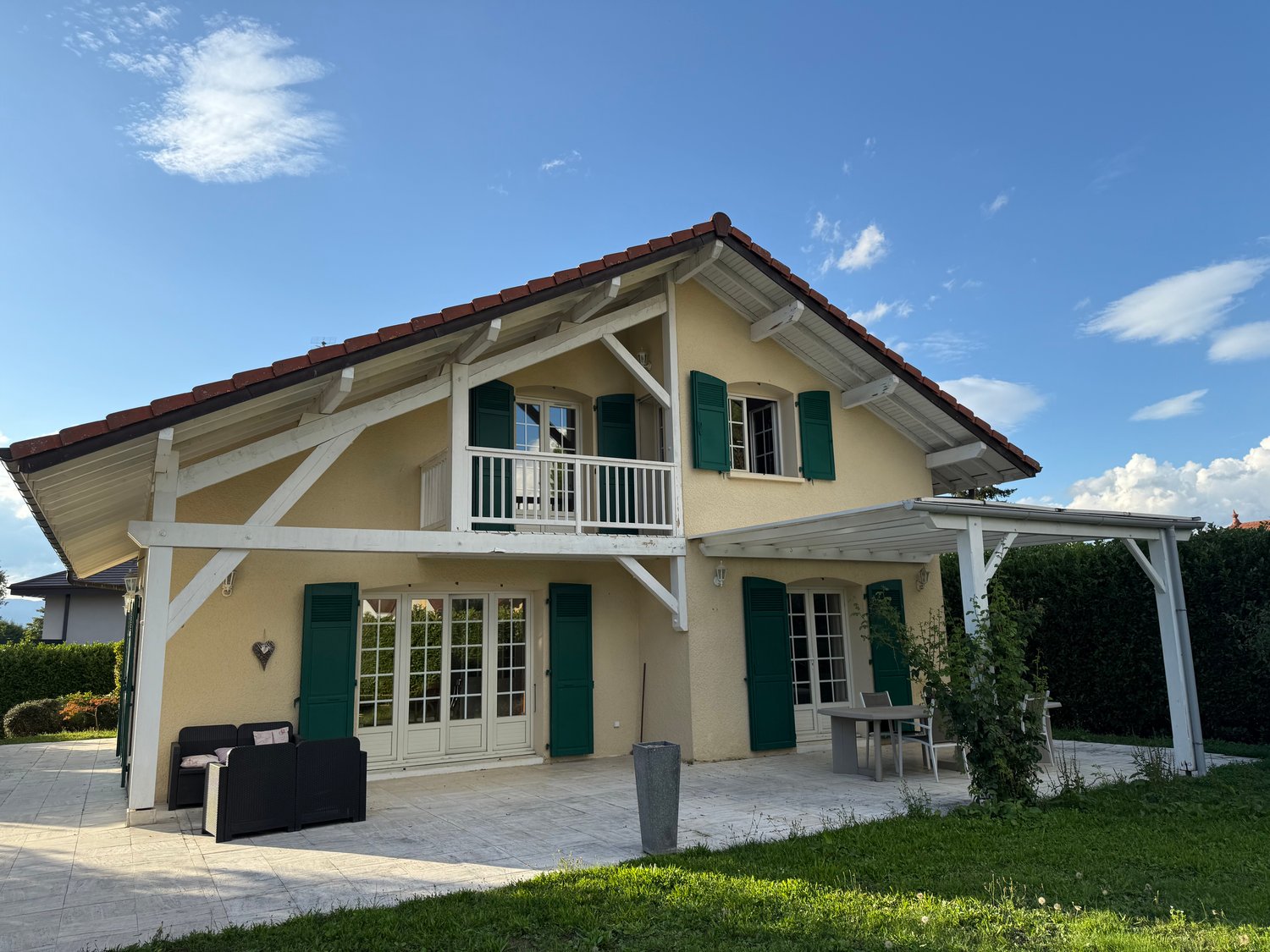 yellow exterior with a terrace and patio area, large windows, modern design