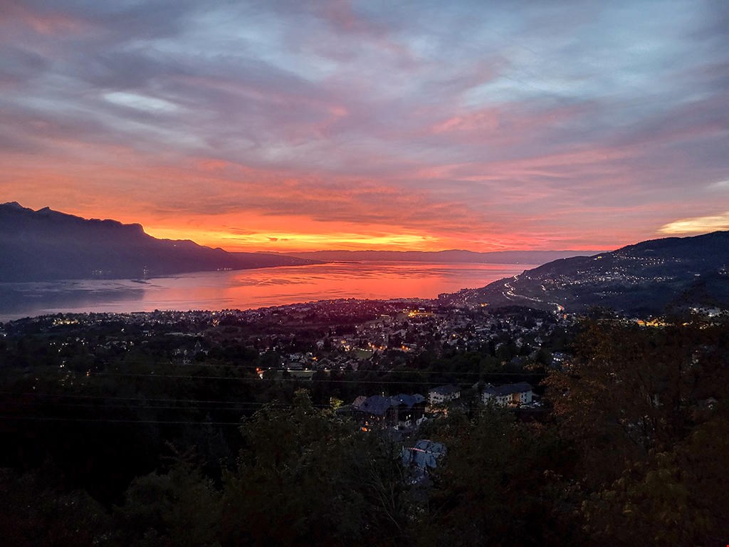 Wide panoramic view over city and sea, during sunset