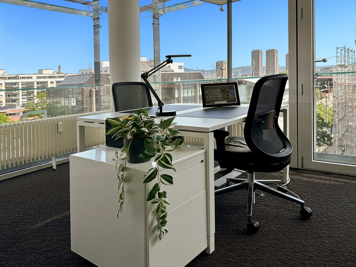white desks and chairs, black swivel chairs, lamp, plant, glass windows, balcony, radiator, office supplies