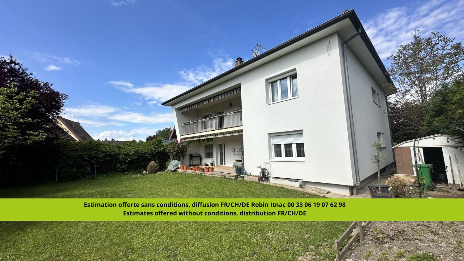 2-story white house with balcony, surrounded by trees and a grassy yard