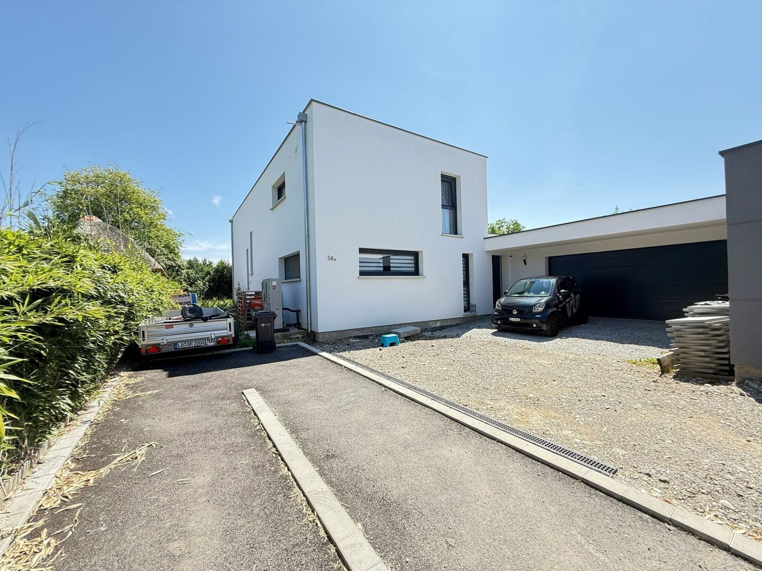 modern white house, garage, driveway, 2 cars parked