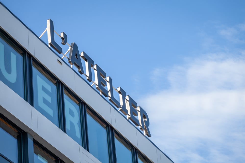 Modern multi-story building with large windows and the name 'Lufthansa' prominently displayed on the facade.
