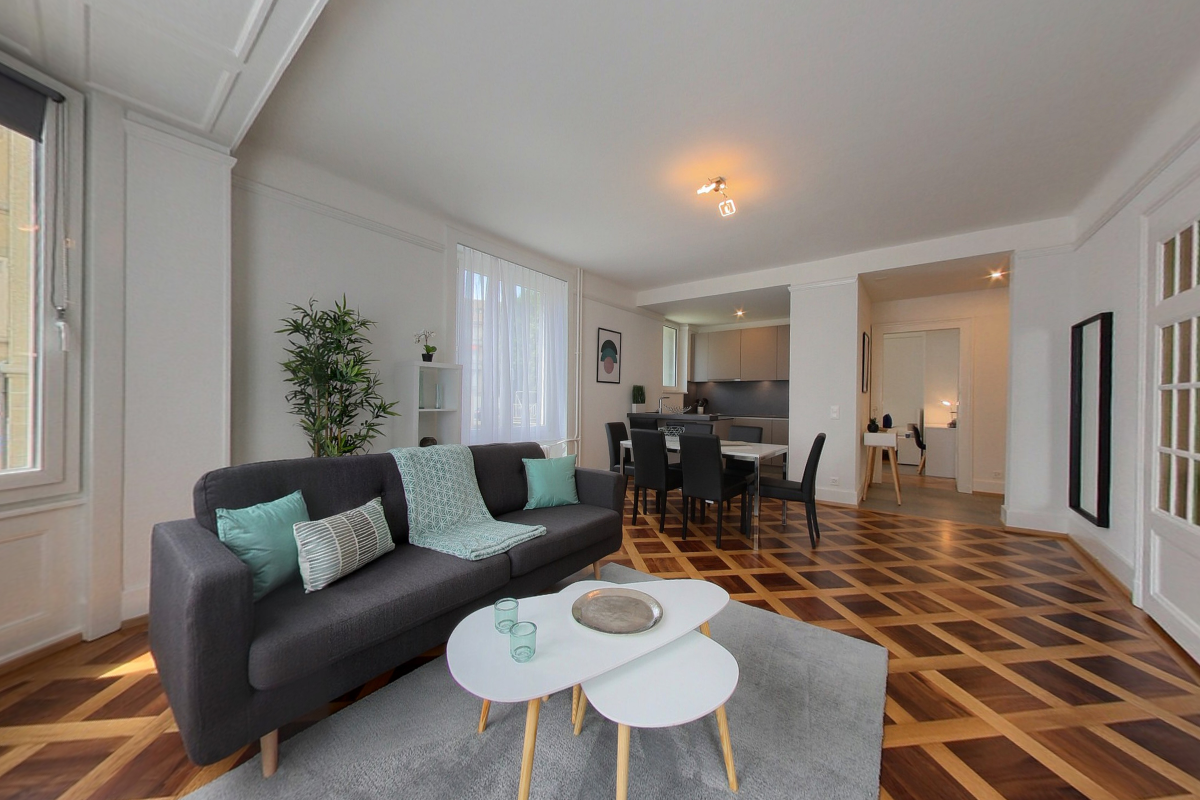 large couch, coffee table, dining table, hardwood floors